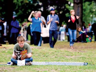 Courtesy of Metro News: Dante Petitti reads amid festival-goers at The Word on The Street literary festival, held in and around Queen’s Park. He was reading a comic called The Possum, by Blair Kitchen. This is the festival’s 20th year.